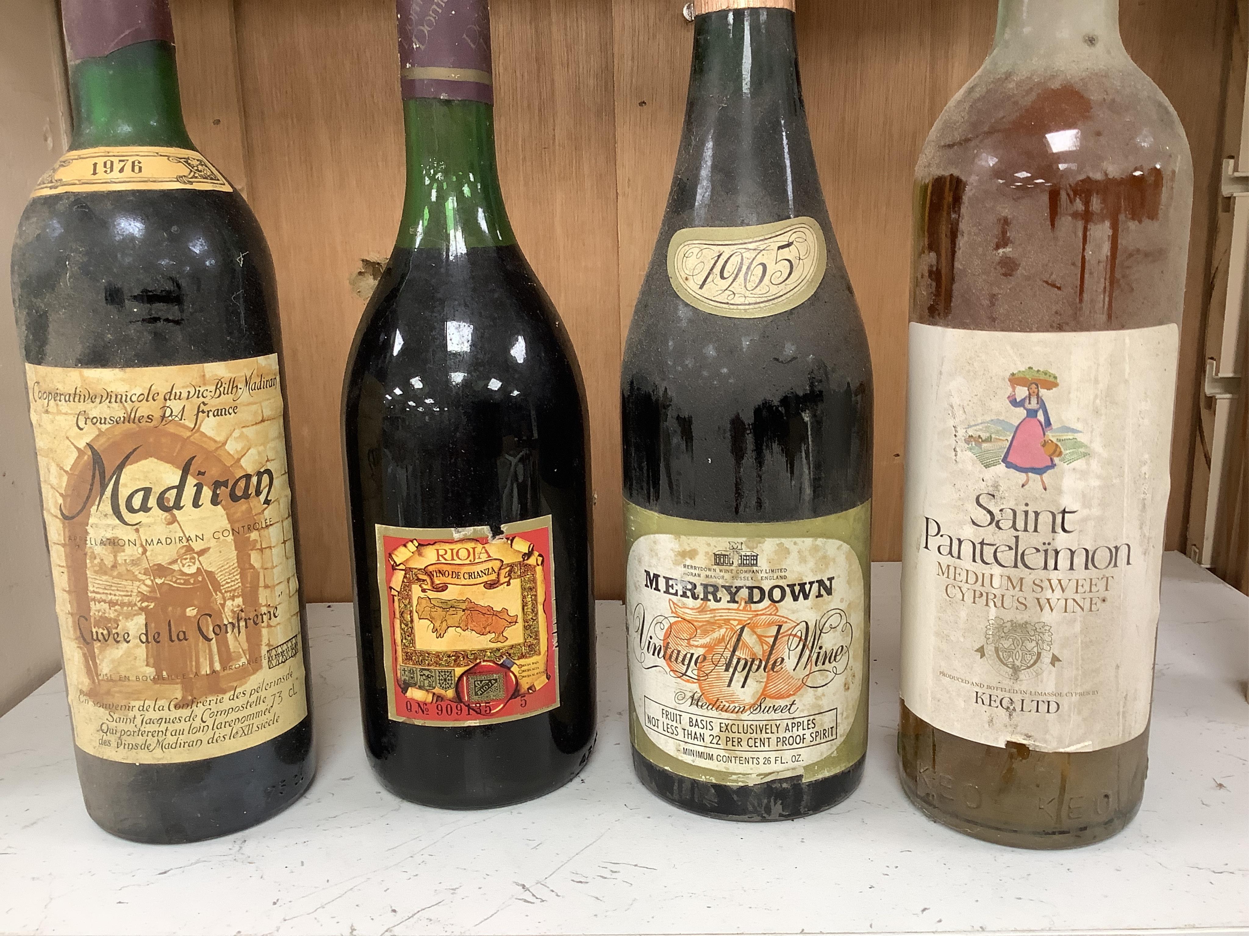 Fifteen bottles of wine and fortified wine, including; a Sandeman 1963 port, four bottles of Chateau La Rose Capbern 1953, a 1976 Madiran Cuvee de la Confrerie, etc. Condition - poor to fair, storage history unknown